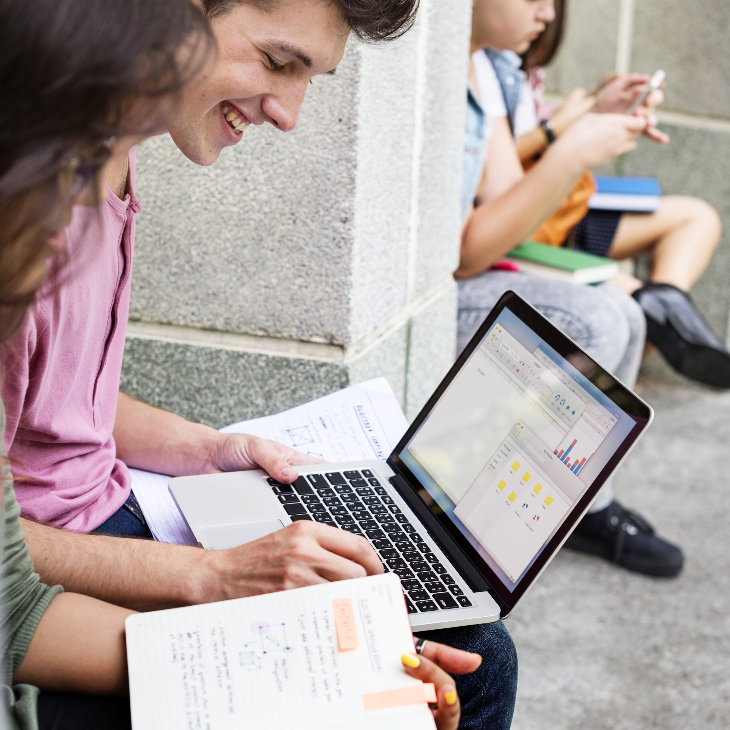 students doing homework in the park